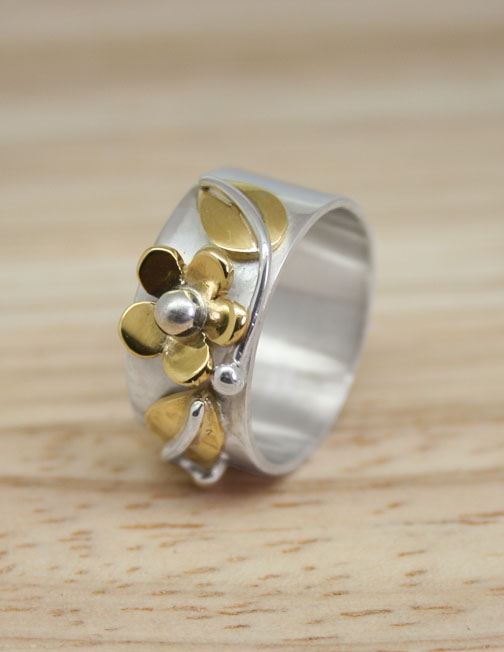 Silver ring with brass flower and leaves