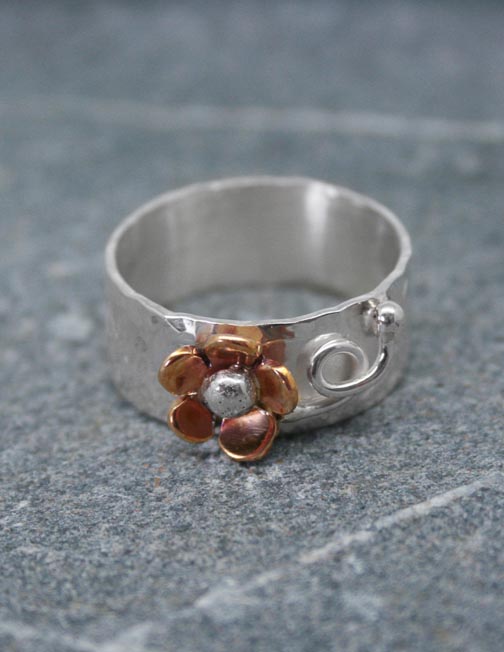 Sterling silver band ring with copper daisy and silver detail