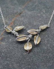 Silver pendant with brass leaves
