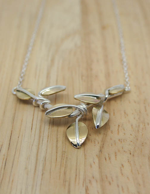 Silver pendant with brass leaves