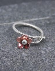 Silver ring with copper daisy
