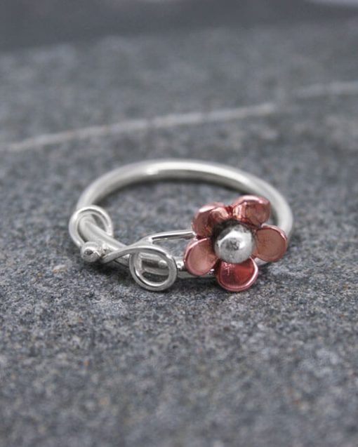 Silver ring with copper daisy