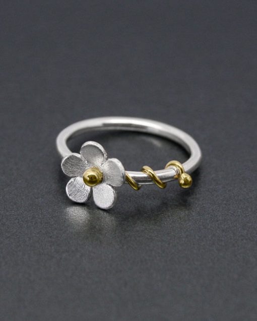 Silver daisy ring with brass tendrils