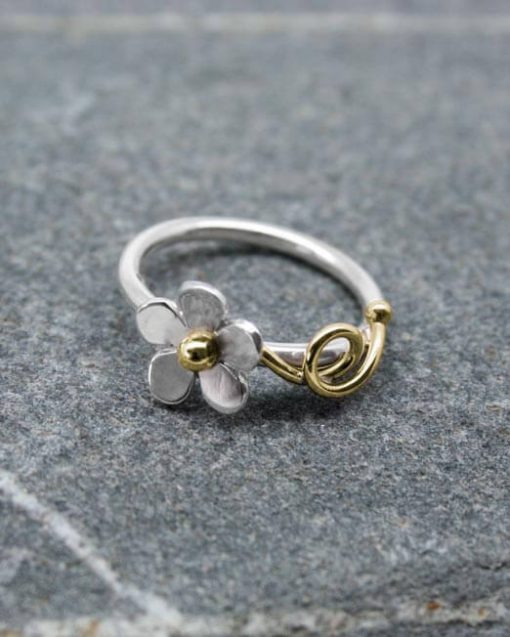 Silver daisy ring with brass tendrils