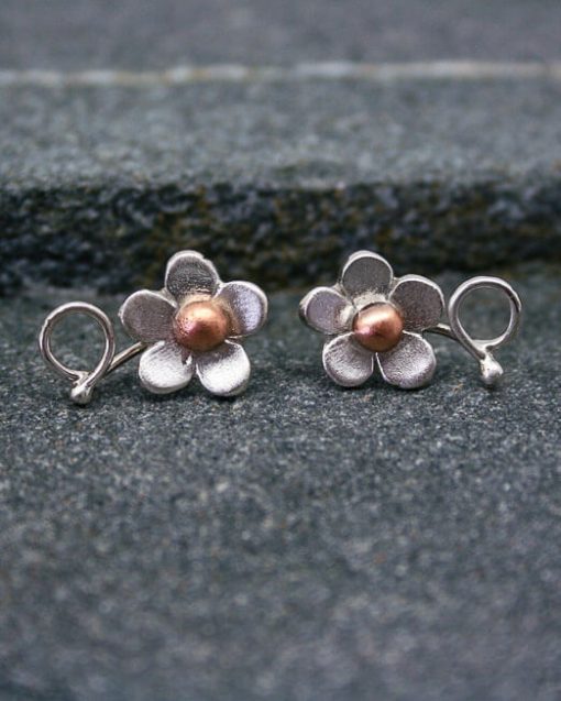 Handmade silver flower studs with copper or brass centres